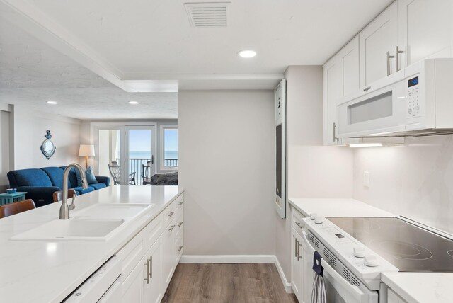 191 E Grand Ave Unit 606, Old Orchard Beach, ME 04064 - kitchen with white appliances, dark wood-style flooring, a sink, open floor plan, and recessed lighting