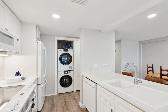 191 E Grand Ave Unit 606, Old Orchard Beach, ME 04064 - washroom featuring estacked washer and dryer, light wood-style floors, recessed lighting, and baseboards