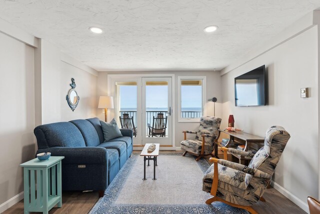 191 E Grand Ave Unit 606, Old Orchard Beach, ME 04064 - living area with baseboards, wood finished floors, recessed lighting, and a textured ceiling