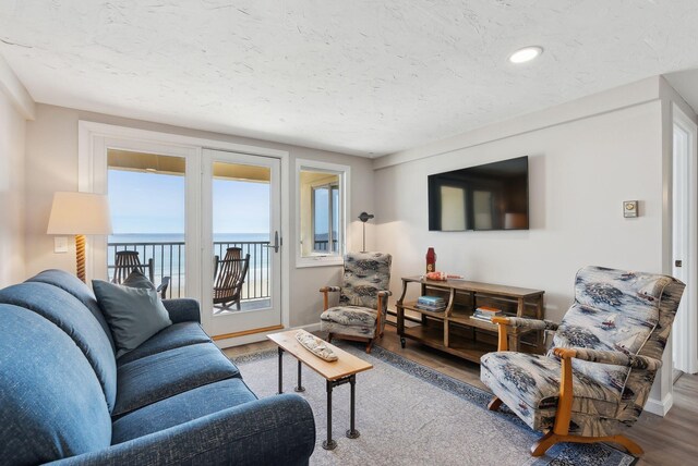 191 E Grand Ave Unit 606, Old Orchard Beach, ME 04064 - living room with wood finished floors, baseboards, a textured ceiling, and recessed lighting