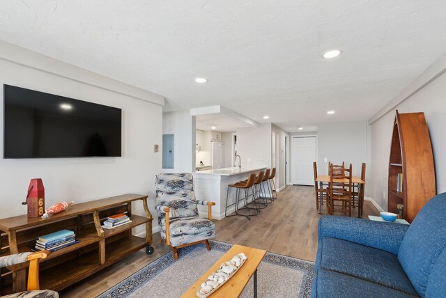 191 E Grand Ave Unit 606, Old Orchard Beach, ME 04064 - living room featuring light wood-style flooring, baseboards, recessed lighting, and electric panel