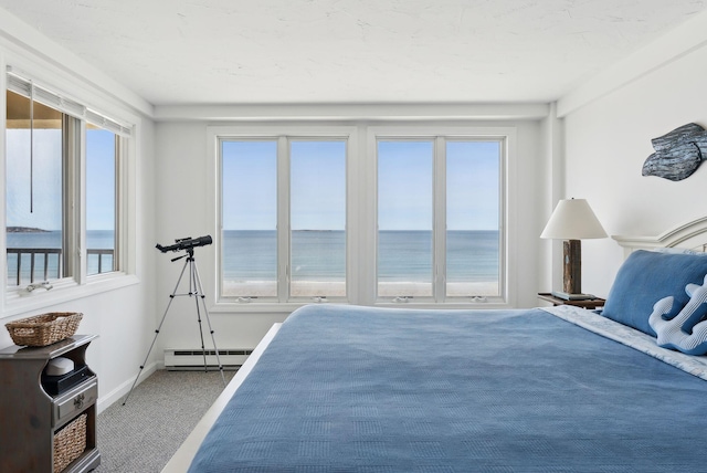 191 E Grand Ave Unit 606, Old Orchard Beach, ME 04064 - bedroom featuring a baseboard radiator, carpet flooring, a water view, and baseboards