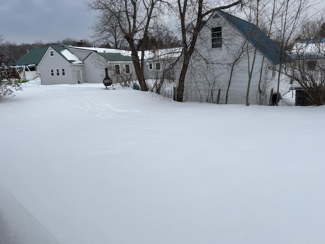 snowy yard with a garage