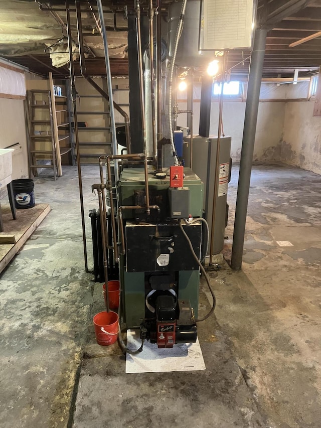 utility room featuring water heater and a heating unit