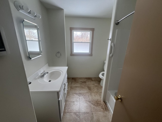 bathroom featuring a healthy amount of sunlight, toilet, a shower, and vanity