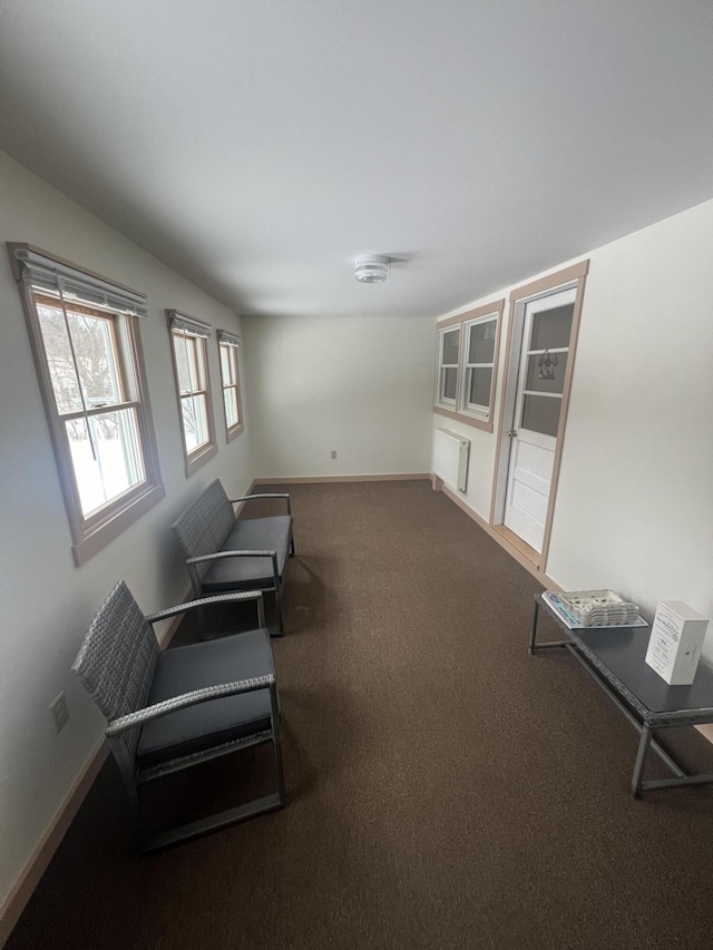 sitting room featuring carpet flooring and baseboards