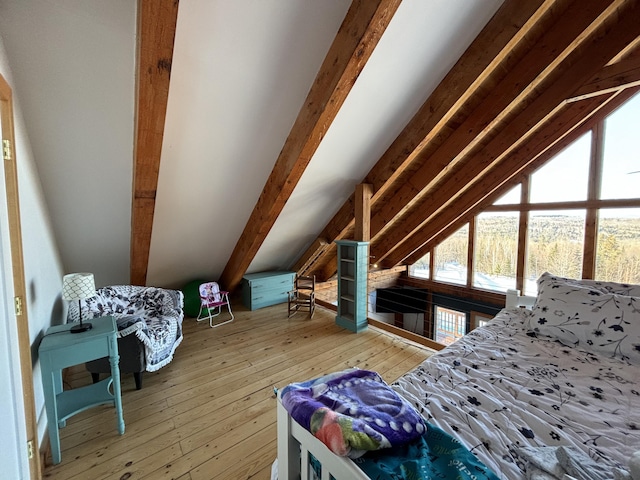 bedroom featuring lofted ceiling with beams and hardwood / wood-style floors