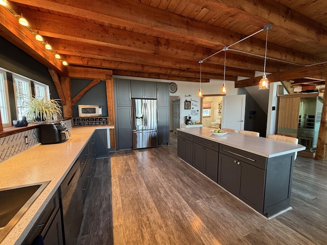 kitchen featuring dishwashing machine, white microwave, dark wood-style floors, stainless steel refrigerator with ice dispenser, and beam ceiling