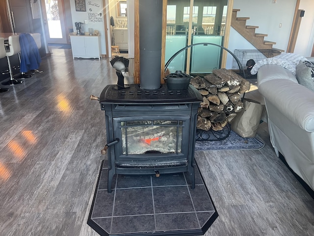 details featuring a wood stove, washer / clothes dryer, and wood finished floors