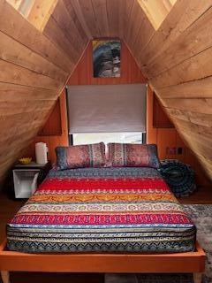 bedroom featuring wood ceiling and vaulted ceiling