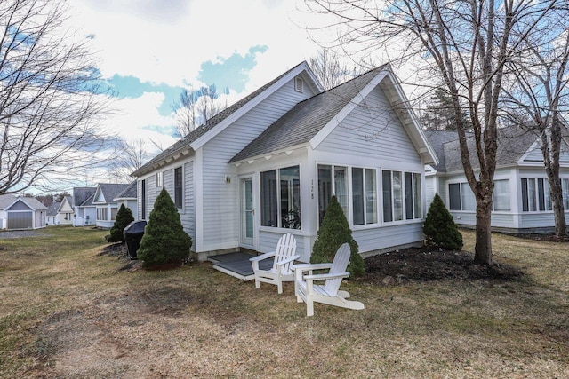 454 Post Rd Unit 128, Wells, ME 04090 - rear view of property with roof with shingles, a yard, and a sunroom