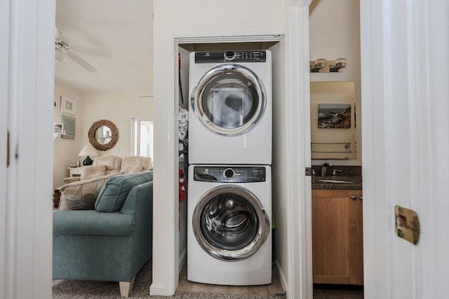 454 Post Rd Unit 128, Wells, ME 04090 - washroom featuring a ceiling fan, tile patterned floors, a sink, stacked washing maching and dryer, and laundry area