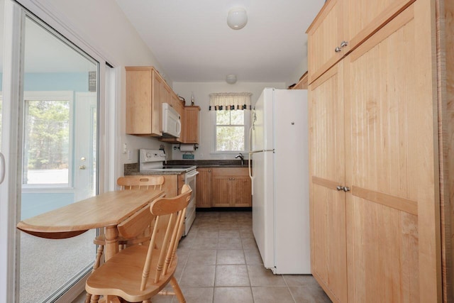 454 Post Rd Unit 128, Wells, ME 04090 - kitchen with dark countertops, a sink, light brown cabinetry, light tile patterned flooring, and white appliances