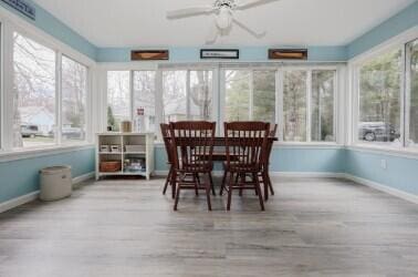 454 Post Rd Unit 128, Wells, ME 04090 - sunroom featuring baseboards and wood finished floors