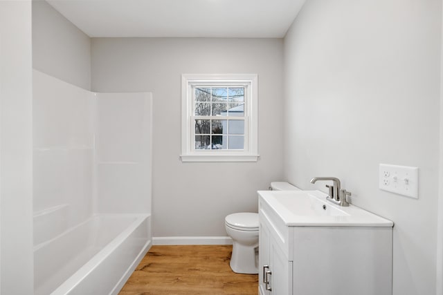 full bathroom with toilet, baseboards, wood finished floors, and vanity