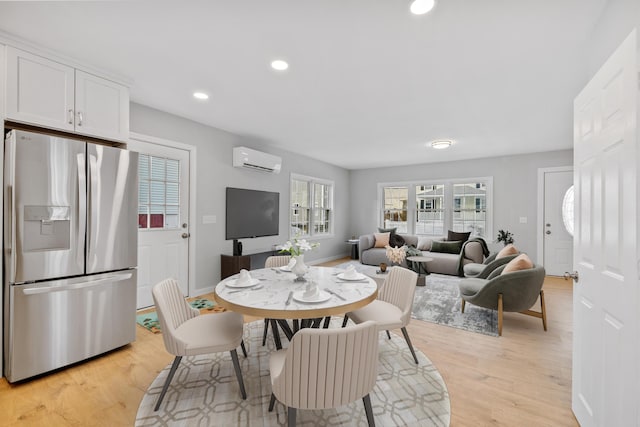 dining space with baseboards, a wall mounted air conditioner, light wood-style flooring, and recessed lighting