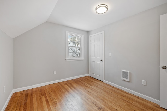 bonus room with light wood-style floors, lofted ceiling, and baseboards