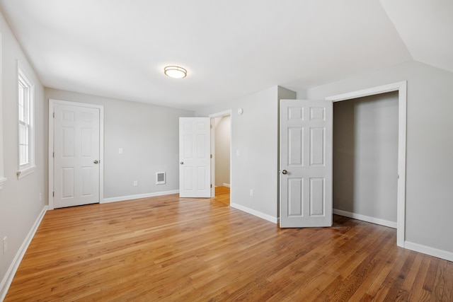 unfurnished bedroom featuring light wood-style flooring, visible vents, and baseboards