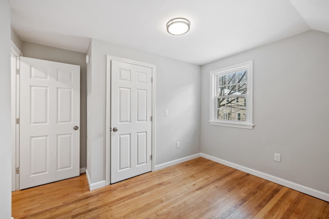 unfurnished bedroom with light wood-type flooring and baseboards