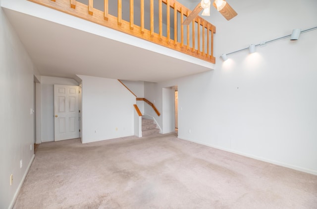 34 Parkwood Dr Unit 203, Augusta, ME 04330 - unfurnished living room with stairway, carpet flooring, a ceiling fan, and baseboards