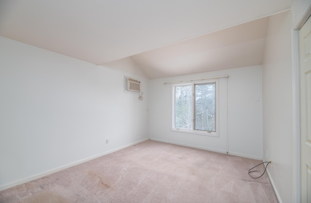 34 Parkwood Dr Unit 203, Augusta, ME 04330 - spare room featuring lofted ceiling, carpet flooring, baseboards, and a wall mounted air conditioner