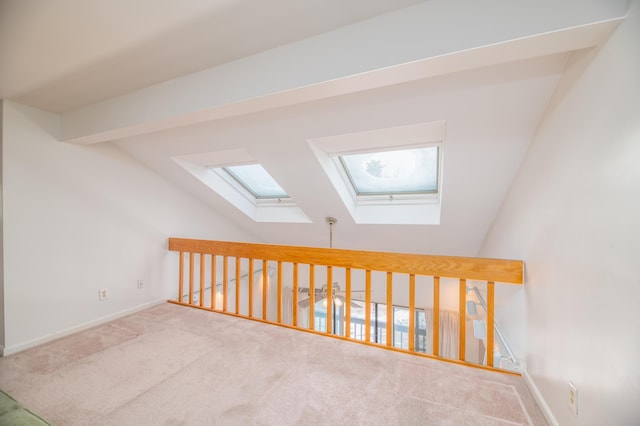 34 Parkwood Dr Unit 203, Augusta, ME 04330 - bonus room featuring a skylight, lofted ceiling, carpet floors, and baseboards