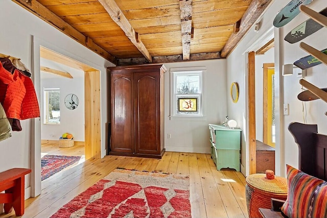 foyer with wooden ceiling, beam ceiling, and light wood-style floors