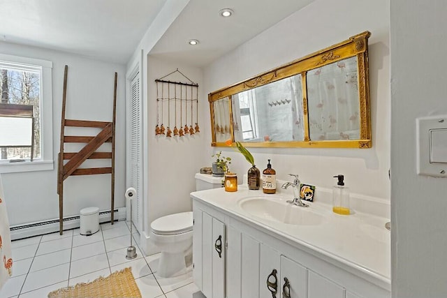 bathroom with vanity, baseboard heating, tile patterned flooring, and toilet