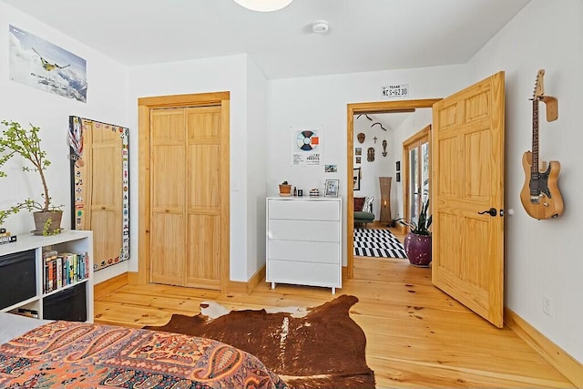 bedroom featuring light wood-type flooring and baseboards