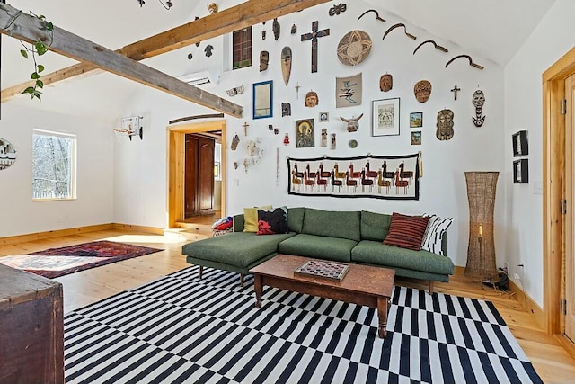 living room featuring high vaulted ceiling, beam ceiling, baseboards, and light wood finished floors