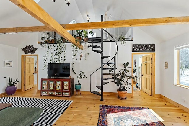 living room with high vaulted ceiling, hardwood / wood-style flooring, baseboards, stairway, and beamed ceiling