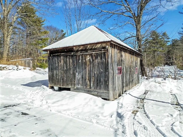 snow covered structure with an outdoor structure