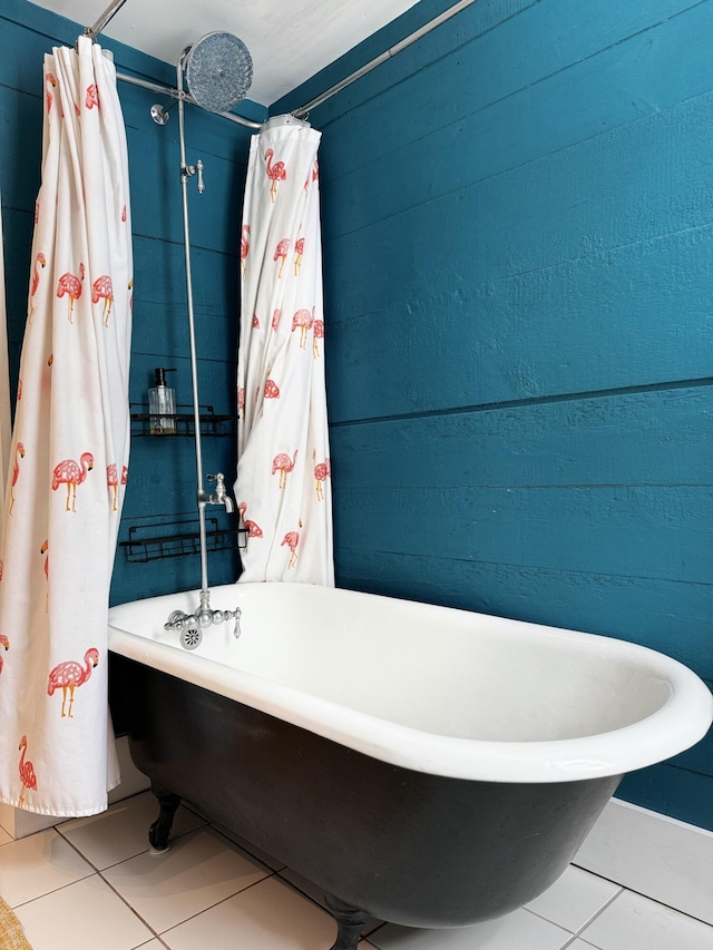 full bath featuring tile patterned flooring and a soaking tub