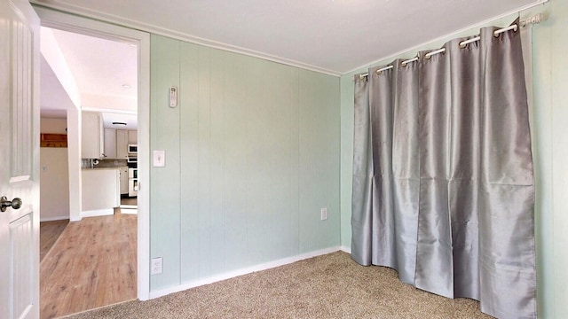 unfurnished room featuring light colored carpet