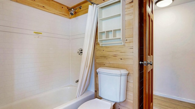 full bath with wood finished floors, toilet, and shower / bath combo