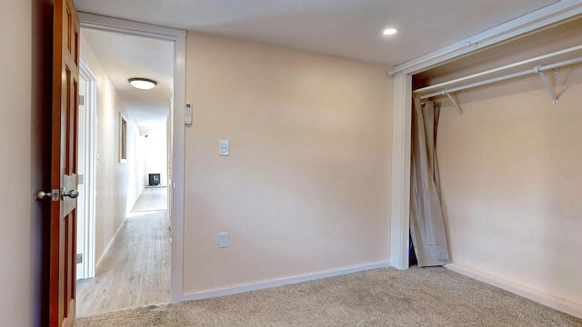 unfurnished bedroom with baseboards and light carpet