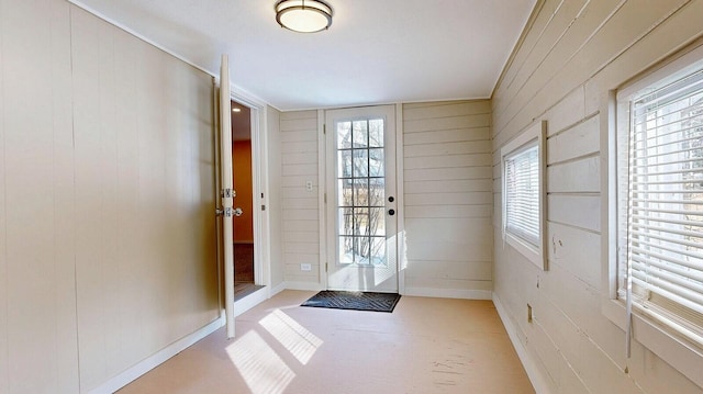 doorway with baseboards and plenty of natural light