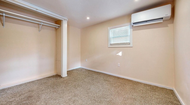 unfurnished bedroom featuring carpet flooring, recessed lighting, baseboards, and a wall mounted air conditioner