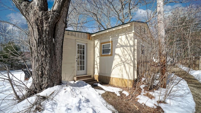 snow covered structure with entry steps