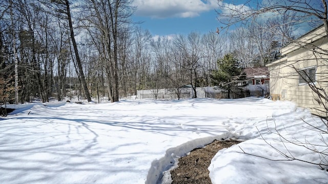 snowy yard with fence