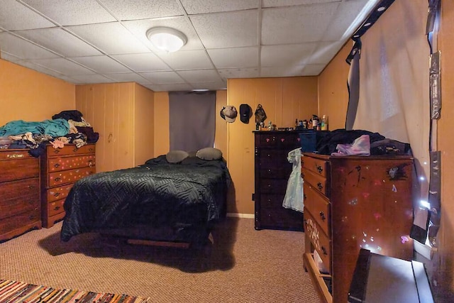 bedroom featuring a drop ceiling and carpet flooring