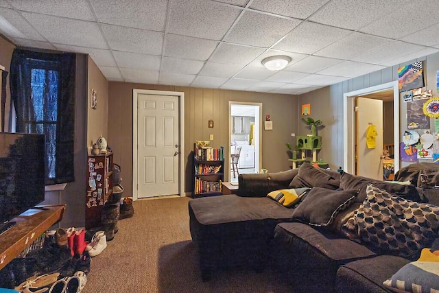 living room featuring carpet floors and a paneled ceiling