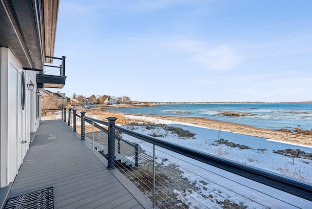 wooden terrace with a water view and a beach view