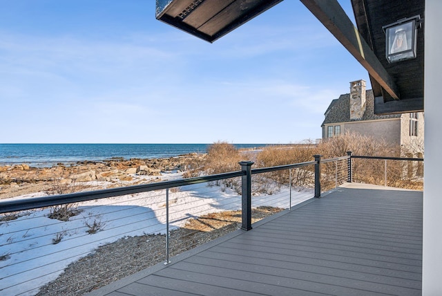 deck featuring a water view and a beach view