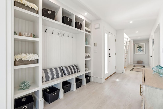 mudroom featuring built in shelves, wood finished floors, and recessed lighting