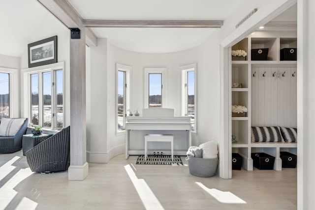 mudroom featuring built in features, baseboards, beam ceiling, and wood finished floors