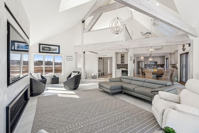 living area with a chandelier and high vaulted ceiling