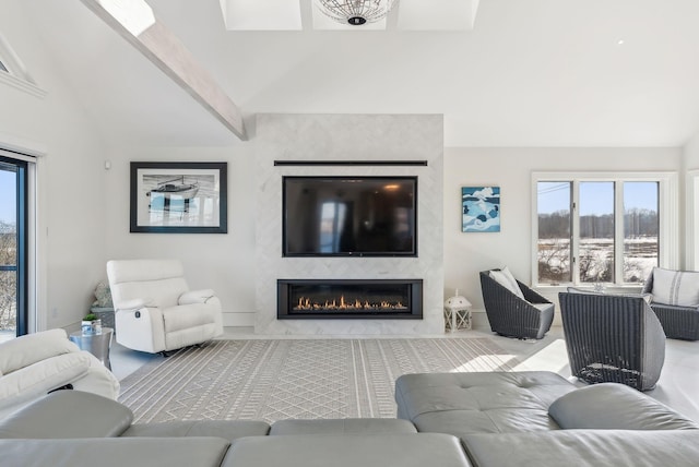 living room featuring vaulted ceiling with beams and a fireplace