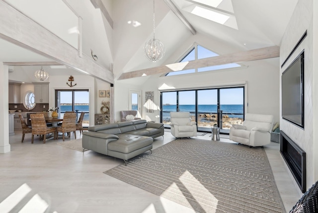 living area with a chandelier, beam ceiling, high vaulted ceiling, and light wood-style flooring