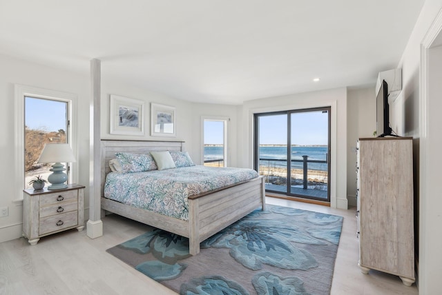 bedroom with access to outside, baseboards, and light wood finished floors